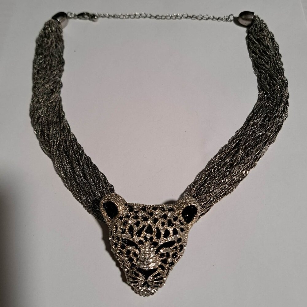 Jaguar leopard head pendant on a multichain silver tone necklace